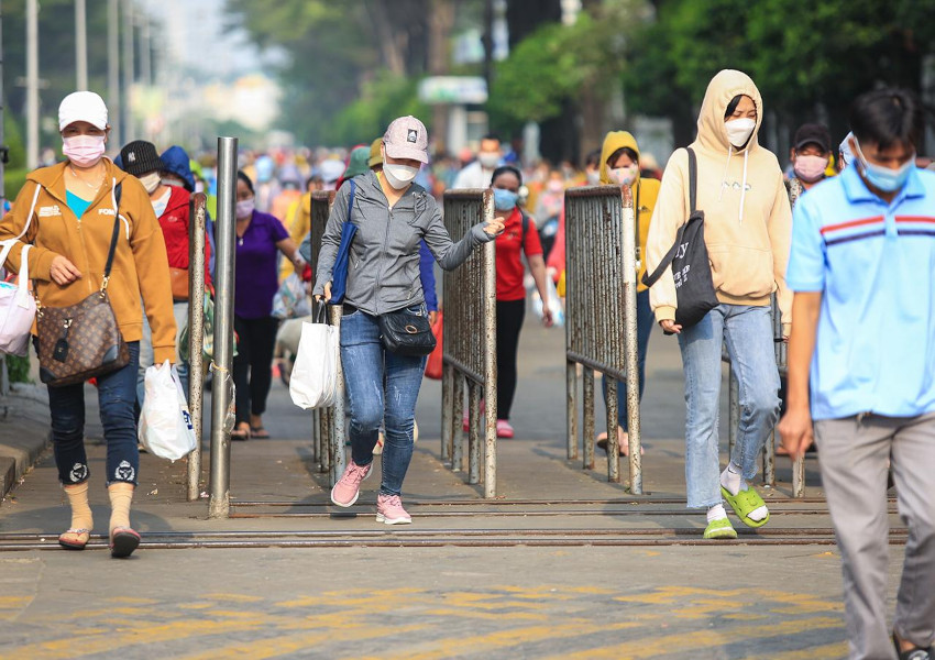 Vietnamese workers going out of a shoes factory